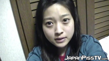 Adorable Japanese chick sits on the toilet and pees in a cup